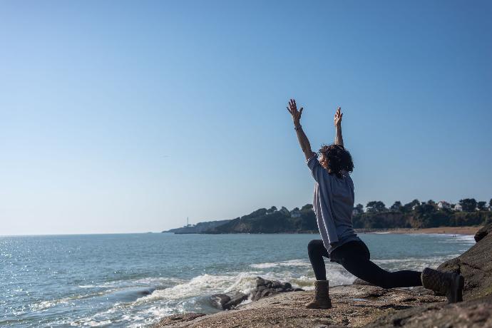 Posture Anjaneyasana face à la mer